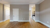 This inviting two-story residence offers a harmonious blend of comfort and functionality across its 1,480 square feet. The ground floor showcases an open-concept layout, seamlessly connecting the kitchen and living areas. Gleaming hardwood floors extend throughout, complemented by neutral-toned walls that create a bright, airy atmosphere. A striking staircase with white balusters leads to the upper level, where three bedrooms, including a generous 190 square foot primary suite, await. Large windows and glass doors flood the space with natural light, while a ceiling fan ensures comfort. The home's two bathrooms and additional closet space provide ample storage and convenience. With its clean lines, modern fixtures, and thoughtful design, this residence offers a perfect canvas for contemporary living.