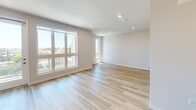 Located at 398 West Valley Boulevard in San Gabriel, CA, this thoughtfully designed single-floor studio offers a bright and modern living experience. The open-concept layout seamlessly connects the kitchen and living area, creating an efficient and inviting space throughout. Light wood plank flooring runs throughout, complementing the clean white walls and recessed lighting that keep the interior feeling airy and fresh. Large windows in the living area flood the space with natural light while framing pleasant outdoor views of the surrounding neighborhood. The contemporary kitchen is a standout feature, equipped with warm-toned wood cabinetry, gleaming white quartz countertops, a peninsula island with an undermount sink, and stainless steel appliances including a gas range, built-in microwave, dishwasher, and refrigerator. Stylish pendant lights hang above the island, adding a refined touch to the culinary space. The living area is generously proportioned, offering a versatile layout for both relaxing and entertaining. The bathroom is finished to a high standard, featuring a full bathtub and shower combo enclosed by sleek frameless sliding glass doors, set against crisp white tile surround. A stacked washer and dryer unit is also conveniently included within the unit, adding practical everyday functionality.