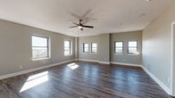 Located in the heart of Memphis, TN (38103), this well-appointed 2-bedroom, 2-bathroom residence delivers a thoughtfully designed single-floor layout with a cohesive, modern aesthetic throughout. Rich, dark hardwood-style flooring flows seamlessly across the entire unit, complemented by neutral gray walls and crisp white trim that create a clean, contemporary feel.

The expansive open-concept living area is bathed in natural light from multiple windows, offering impressive views of the surrounding cityscape and what appears to be the Mississippi River beyond. Ceiling fans are present throughout, adding both comfort and character to each room.

The kitchen features white shaker-style cabinetry, marble-look countertops, stainless steel appliances including a range and refrigerator, and a peninsula that opens to the main living space — ideal for entertaining or everyday functionality.

Both bedrooms are generously sized with large windows framing urban views and ceiling fans overhead. The primary bedroom includes a walk-in closet with built-in shelving. Each of the two bathrooms is finished with tile flooring, white vanity cabinetry, and warm granite-style countertops, with one featuring a full tub-shower combination.