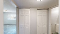 Located at 4323 N Division St in Davenport, Iowa, this two-bedroom, one-bathroom unit offers a practical and efficiently designed single-floor layout. The space features a neutral color palette throughout, creating a clean and cohesive aesthetic.

The kitchen is equipped with white shaker-style cabinetry, a double-basin stainless steel sink, granite-style countertops, and a full-size refrigerator. Wood-look vinyl plank flooring runs through the kitchen, hallway, and secondary bedroom areas, adding warmth and durability.

The primary bedroom is generously sized and features plush carpeting, a textured ceiling, and dual bi-fold closets providing ample storage. A window allows for natural light. The secondary bedroom also offers carpeted flooring, neutral walls, and a window with exterior views of surrounding greenery.

The bathroom includes a vanity with a medicine cabinet mirror, a toilet, and a shower-tub combination with a decorative curtain. Textured walls carry throughout the wet areas.

A connecting hallway links the rooms together in a straightforward, functional layout. Textured ceilings are found throughout the unit. Overall, the space presents a tidy, move-in-ready environment well-suited for those seeking a manageable and low-maintenance home in Davenport.