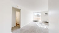 Located at 2390 E Asbury Ave in Denver, CO, this single-floor, 2-bedroom, 2-bathroom residence offers a functional and well-organized layout. The living room is bright and welcoming, featuring large windows with vertical blinds that flood the space with natural light, plush carpeting, and a baseboard heating system. A wall-mounted air conditioning unit adds year-round comfort. The living area flows into a dedicated dining room, creating a natural separation of spaces. The kitchen connects conveniently to the dining area, with wood-look flooring that contrasts the carpeted living zones. Both bedrooms are generously proportioned, each equipped with ceiling fans, large windows, and sliding closet doors for ample storage. The primary bedroom benefits from great natural light and direct access to a hallway. The two bathrooms are clean and efficiently designed; one features a white shaker-style vanity with brushed gold fixtures, a tub-shower combo with built-in shelving, and wood-look flooring. Throughout the residence, crisp white walls and neutral tones create a bright, cohesive aesthetic. Five closets distributed across the floor plan ensure exceptional storage capacity for a residence of this scale.