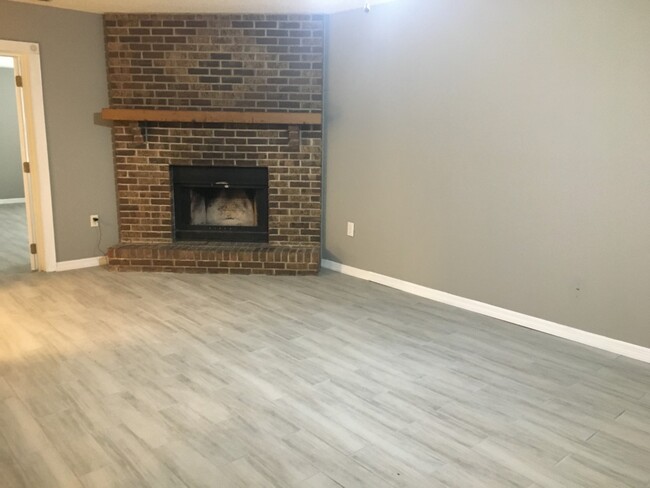 living room with wood burning fireplace - 3858 Dovehollow Dr
