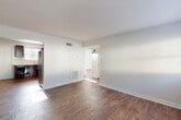 Located in Atlanta's 30318 zip code, this two-bedroom, one-bathroom single-floor residence offers a straightforward and functional layout. Rich, wood-look flooring runs consistently throughout the home, anchoring each room with warmth against the clean white walls and trim.

The living room is a bright, open space with neutral tones, a wall-mounted electrical panel, and easy flow into the adjacent kitchen. The kitchen is well-equipped with dark espresso cabinetry, light countertops, a stainless steel refrigerator, black electric range, dishwasher, and a window above the sink that brings in natural light. A door in the kitchen provides direct exterior access.

The primary bedroom is generously proportioned and features a dual closet, providing ample storage. The second bedroom benefits from a large window with natural light and its own closet. A connecting hallway ties the bedrooms and bathroom together efficiently. The bathroom includes a full tub-shower combination with white subway tile surround and a window for ventilation.

Additional spaces include a utility room and multiple closets distributed throughout the home. The consistent flooring, neutral palette, and practical layout make this a well-organized residence in Atlanta.