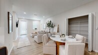 Located at 605 4th Avenue Northwest in Largo, FL, this single-story 2-bedroom, 3-bathroom home offers a thoughtfully designed layout with a clean, modern aesthetic. Light hardwood flooring and a soft neutral color palette flow seamlessly throughout, creating a cohesive and inviting atmosphere.

The open-concept living and dining area is anchored by recessed lighting and large windows that invite natural light into the space. The kitchen is outfitted with white shaker cabinetry, quartz countertops, a subway tile backsplash, and stainless steel appliances, including a side-by-side refrigerator with ice maker, range, and built-in microwave.

The primary bedroom is a comfortable retreat featuring a ceiling fan, natural light from a window with blinds, and a closet with built-in shelving. The en-suite bathroom includes a dual-sink vanity with white cabinetry, quartz countertops, framed mirrors, and a glass-enclosed walk-in shower. The second bedroom also features wood flooring, a closet, and convenient access to the hallway.

Three full bathrooms ensure ample convenience for residents and guests. A dedicated laundry room houses a full-size Maytag washer and dryer. Additional storage is provided by three closets throughout the home, enhancing the overall functionality of this well-organized residence.