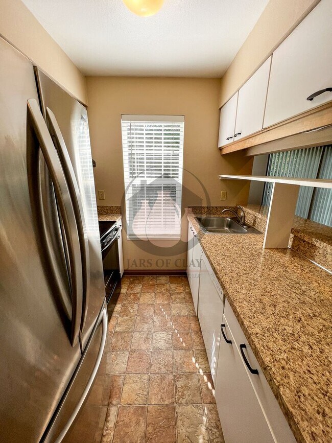 Building Photo - Adorable Ground Level Charbonneau Condo - ...