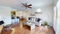 Located at 8134 Colonial Village Dr in Tampa, FL, this 2-bedroom, 2-bathroom residence offers a thoughtfully designed single-floor layout that maximizes comfort and functionality. The open-concept living and dining area is anchored by warm hardwood-style flooring, a ceiling fan, and French doors that flood the space with natural light and provide access to a private balcony. Floating shelves add a modern touch to the living room walls.

The galley-style kitchen features rich dark cabinetry, granite countertops, stainless steel appliances, and hardwood-style flooring, with convenient access to an in-unit laundry area.

Both bedrooms are carpeted and include ceiling fans for year-round comfort. The spacious primary bedroom benefits from multiple windows and direct access to a generously sized walk-in closet fitted with wire shelving. The second bedroom also features a walk-in closet with ample shelving and hanging space.

Both bathrooms are finished with granite-topped dark wood vanities, hardwood-style flooring, and tub-shower combinations with white tile surrounds. A connecting hallway ties all rooms together for a smooth and practical flow throughout the residence.