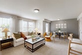 This thoughtfully designed one-bedroom, two-bathroom residence in Temple, TX delivers a comfortable and functional single-floor layout. The open-concept living and dining area is bright and welcoming, featuring plush carpet flooring, multiple windows with blinds that invite natural light, and a seamless flow between lounging and dining spaces. The kitchen is well-appointed with rich dark cabinetry, light quartz-style countertops, wood-look tile flooring, and stainless steel appliances including a side-by-side refrigerator with ice maker — offering both style and practicality. The generously sized bedroom provides a peaceful retreat, complete with a ceiling fan, soft carpet, and a window that allows in natural light. A walk-in closet with wire shelving offers ample storage. Both bathrooms are finished with wood-look tile flooring and clean white subway tile, with one featuring a full tub/shower combination. A hallway connects the spaces efficiently, adding to the unit's cohesive and organized flow. Neutral tones throughout create a calm, modern ambiance well-suited for comfortable everyday living in Temple, Texas.