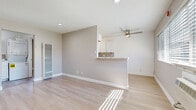 Located at 1151 Turnbull Canyon Rd in Hacienda Heights, CA, this one-bedroom, two-bathroom single-floor unit offers a well-designed layout that maximizes every inch of its compact footprint. Light wood laminate flooring runs throughout the entire space, lending a clean, cohesive aesthetic that ties each room together.

The open-concept living, dining, and kitchen area serves as the heart of the unit. The living area is bright and airy, benefiting from natural light streaming through wide windows and a ceiling fan overhead. A wall-mounted A/C unit provides climate control. The kitchen features white cabinetry, marble-style countertops, a mosaic tile backsplash, and a gas range, with a peninsula that opens to the living space, ideal for casual dining.

The bedroom is a comfortable, well-proportioned retreat complete with a ceiling fan, a window for natural light, and a dedicated closet. One bathroom includes an in-unit stacked washer and dryer, combining practicality with convenience, and features a full soaking tub with white tile surround. A second bathroom provides additional functionality for guests or daily use.

Neutral warm-gray walls throughout create a calm, inviting ambiance that suits a variety of furnishing styles. This thoughtfully laid-out unit offers efficient, modern living in a convenient Southern California location.
