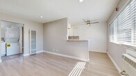 Located at 1151 Turnbull Canyon Rd in Hacienda Heights, CA, this one-bedroom, two-bathroom single-floor unit offers a well-designed layout that maximizes every inch of its compact footprint. Light wood laminate flooring runs throughout the entire space, lending a clean, cohesive aesthetic that ties each room together.

The open-concept living, dining, and kitchen area serves as the heart of the unit. The living area is bright and airy, benefiting from natural light streaming through wide windows and a ceiling fan overhead. A wall-mounted A/C unit provides climate control. The kitchen features white cabinetry, marble-style countertops, a mosaic tile backsplash, and a gas range, with a peninsula that opens to the living space, ideal for casual dining.

The bedroom is a comfortable, well-proportioned retreat complete with a ceiling fan, a window for natural light, and a dedicated closet. One bathroom includes an in-unit stacked washer and dryer, combining practicality with convenience, and features a full soaking tub with white tile surround. A second bathroom provides additional functionality for guests or daily use.

Neutral warm-gray walls throughout create a calm, inviting ambiance that suits a variety of furnishing styles. This thoughtfully laid-out unit offers efficient, modern living in a convenient Southern California location.