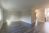 Located at 658 Sierra Vista Ave in Mountain View, CA, this single-floor, one-bedroom residence offers a well-organized and efficiently designed layout. The open living room greets you with elegant crown molding, neutral warm-toned walls, and rich dark hardwood-style flooring that extends throughout the main living areas, creating a cohesive and polished aesthetic. A large window allows natural light to fill the space while offering pleasant views of the surrounding neighborhood's mature trees and rooftops.

The combined kitchen and living area is thoughtfully arranged for everyday functionality. The kitchen features white cabinetry with brushed nickel hardware, granite-style countertops, a stainless steel sink, and stainless steel appliances including a range and dishwasher. A skylight and window provide additional natural illumination, keeping the kitchen bright and airy. Light wood-tone flooring and crown molding continue throughout, tying the spaces together seamlessly.

The bedroom is a comfortable, well-proportioned retreat finished with soft neutral carpet, a large window with outdoor views, and a closet with classic panel doors. The muted gray walls provide a calm and restful atmosphere. Overall, this residence presents a clean, move-in-ready interior with thoughtful finishes and a practical floor plan suited for comfortable everyday living in the heart of Mountain View.