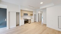 Located at 4365 Bloor St W in Toronto, this thoughtfully designed 2-bedroom, 2-bathroom unit offers a bright and modern living experience. The open-concept layout is anchored by light hardwood flooring throughout, contributing to a clean, cohesive aesthetic.

The kitchen is well-appointed with light wood cabinetry, white quartz countertops, a tiled backsplash, and a full suite of stainless steel appliances including a range, microwave, dishwasher, and refrigerator. Track lighting above and an adjacent closet enhance both function and storage.

The primary bedroom is a comfortable size, featuring a large sliding glass door that opens to a private outdoor balcony with a tiled floor and metal railing. Roller blinds provide light control and privacy. A second bedroom offers similar light-toned finishes, a built-in closet with sliding doors, and direct access to the hallway.

The two bathrooms are finished in neutral toned large-format tile. One features a glass-enclosed walk-in shower, while the second includes a full soaker tub with overhead shower — both fitted with chrome fixtures for a polished look.

The unit's overall design is minimalist and contemporary, with white walls, recessed lighting, and an efficient use of space throughout.