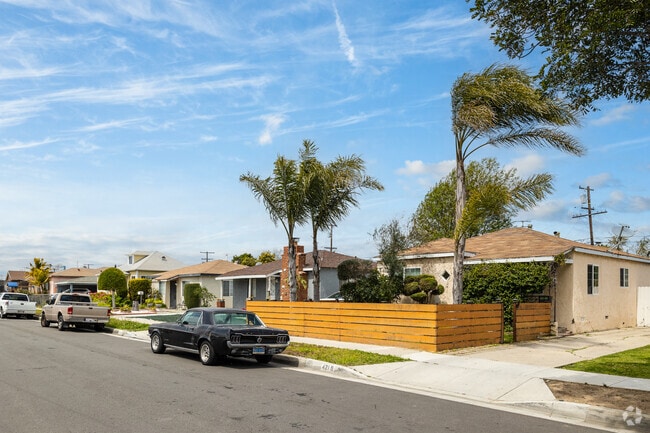 Palm Tree Lined Home With a Wood Paneled Fence in Lawndale