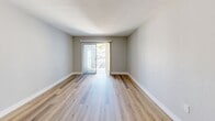 Located at 1915 Maravilla Ave in Fort Myers, Florida, this one-bedroom, one-bathroom unit offers a well-organized single-floor layout designed for comfortable, efficient living. Warm wood-look flooring runs consistently throughout the space, creating a cohesive and inviting atmosphere.

The open-concept living and dining area serves as the heart of the unit, bathed in natural light streaming through a sliding glass door that leads to a private balcony — an ideal spot for enjoying Florida's sunny climate. The kitchen features a pass-through counter with stainless steel appliances, including a refrigerator and microwave, alongside open shelving for added functionality.

A hallway connects the main living area to the bedroom and bathroom. The bedroom is a well-proportioned retreat, complete with a built-in closet with louvered bi-fold doors, a window that brings in natural light, and its own dedicated closet space. In total, three closets throughout the unit provide generous storage options.

The bathroom is finished with a white vanity, granite-style countertop, an undermount sink, and a large mirror, lending a clean and modern aesthetic. Neutral gray walls, white baseboards, and textured ceilings complete the unit's bright, understated design — making it a move-in-ready residence in the heart of Fort Myers.