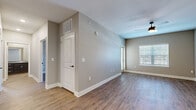Located at 4950 Weaver Rd in Lake Charles, Louisiana, this single-story, three-bedroom, one-bathroom home offers a practical and well-appointed layout across a comfortable footprint. The interior is finished with wood-look flooring throughout, neutral taupe walls, and clean white trim, creating a cohesive and modern aesthetic.

The kitchen is a standout feature, showcasing rich dark cabinetry with brushed nickel hardware, light granite countertops, and black appliances including a full-size refrigerator, electric range, and built-in microwave. The open layout connects well to the main living area, which benefits from a ceiling fan and natural light through a window fitted with blinds.

Each of the three bedrooms offers hardwood-style flooring and windows with blinds for natural light. The primary bedroom is a comfortable size and includes access to a dedicated walk-in closet equipped with wire shelving for organized storage. The full bathroom features a tub-shower combination, granite vanity, and wood-look flooring.

A dedicated in-unit laundry room accommodates a full-size washer and dryer with additional wire shelving above. A hallway connects the various rooms efficiently, completing this well-organized and move-in ready home.