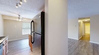 This single-floor residence offers a well-organized layout with a cohesive, neutral color palette of warm beige and white tones throughout. The living areas are finished with wood-style plank flooring that adds warmth and durability, while textured ceilings lend a classic character to the space.

The kitchen is equipped with warm-toned wood cabinetry, a black refrigerator, an electric range, and a built-in dishwasher. A double sink sits beneath a window that allows natural light to filter in, and a ceiling fan overhead provides additional ventilation. The kitchen flows naturally toward a casual dining area, making the space practical for everyday living.

The living room is generously sized with ample wall space, wood-style flooring, and a window fitted with blinds that provides a connection to the outdoors while maintaining privacy. The open sightlines from the living area toward the entry create an airy, connected feel.

The bedrooms are finished with plush carpeting and feature windows with blinds for natural light control. Each room offers a clean, versatile canvas well-suited for a variety of furniture arrangements. Additional areas include transitional spaces with continued wood-style flooring, providing functional connectivity between rooms. The overall layout is practical and comfortable, designed to support everyday living with ease.