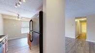 This single-floor residence offers a well-organized layout with a cohesive, neutral color palette of warm beige and white tones throughout. The living areas are finished with wood-style plank flooring that adds warmth and durability, while textured ceilings lend a classic character to the space.

The kitchen is equipped with warm-toned wood cabinetry, a black refrigerator, an electric range, and a built-in dishwasher. A double sink sits beneath a window that allows natural light to filter in, and a ceiling fan overhead provides additional ventilation. The kitchen flows naturally toward a casual dining area, making the space practical for everyday living.

The living room is generously sized with ample wall space, wood-style flooring, and a window fitted with blinds that provides a connection to the outdoors while maintaining privacy. The open sightlines from the living area toward the entry create an airy, connected feel.

The bedrooms are finished with plush carpeting and feature windows with blinds for natural light control. Each room offers a clean, versatile canvas well-suited for a variety of furniture arrangements. Additional areas include transitional spaces with continued wood-style flooring, providing functional connectivity between rooms. The overall layout is practical and comfortable, designed to support everyday living with ease.