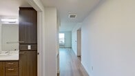 This contemporary 560 square foot apartment in Vancouver, WA, offers a thoughtful blend of style and functionality. The open-concept design seamlessly integrates the living room and kitchen, creating a spacious feel despite the compact footprint. The kitchen is a standout feature, boasting modern wood-grain cabinetry, stainless steel appliances, and a generous island with a sink, perfect for both meal prep and casual dining.

The bedroom, measuring 140 square feet, provides ample space and includes a sliding door closet for storage. The bathroom continues the modern aesthetic with a floating vanity and clean lines. Throughout the apartment, large windows flood the space with natural light and offer expansive city views, enhancing the sense of openness.

Flooring varies between rooms, with plush carpeting in the bedroom for comfort and sleek wood-look flooring in the living areas for easy maintenance. The neutral color palette, predominantly whites and wood tones, creates a versatile backdrop for personal decor.

Additional features include a hallway for improved flow, built-in storage solutions, and contemporary lighting fixtures. This well-designed apartment maximizes every square foot, making it an ideal choice for those seeking a modern, low-maintenance living space in an urban setting.