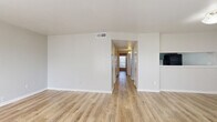Located at 13658 O'Connor Rd in San Antonio, Texas, this single-story 2-bedroom, 1-bathroom home offers a clean, modern aesthetic with a practical and well-organized layout. Light wood-look luxury vinyl flooring runs consistently throughout the entire space, lending a cohesive and contemporary feel to every room.

The open living area is bright and welcoming, with neutral-toned walls, flush-mount lighting, and a pass-through window connecting to the kitchen. The kitchen features dark cabinetry with a contrasting light countertop and built-in appliances, along with an adjacent pantry for added storage convenience.

Both bedrooms are comfortably sized with natural light streaming in through horizontal-blind-fitted windows. Ceiling fans are installed in each bedroom, providing both comfort and ambiance. Each bedroom includes dedicated closet space, and the home boasts a total of four closets, offering generous storage throughout.

The bathroom is well-appointed with a large vanity featuring gray cabinetry, a white countertop, a wide mirror with overhead lighting, and a tiled soaking tub. A utility room and dedicated laundry area round out the functional amenities. The overall design is clean, move-in ready, and efficiently utilizes every square foot of the home.