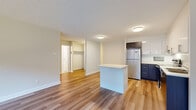 Located at 5160 Avenue Gatineau in Montréal, QC, this well-appointed 1-bedroom, 1-bathroom unit offers a thoughtfully designed single-floor layout with a clean, contemporary aesthetic throughout. Light wood laminate flooring runs continuously across all rooms, creating a cohesive and bright atmosphere.

The open-concept living and kitchen area forms the heart of the unit. The kitchen is equipped with stainless steel appliances, including a full-size refrigerator, an electric range, and an over-the-range microwave. Cabinetry features a striking two-tone design — dark wood lower cabinets paired with crisp white upper cabinets — complemented by white countertops. A central kitchen island provides additional counter space and serves as a natural divider between the kitchen and the living area.

The living area is generously proportioned, with large windows along the exterior wall that admit abundant natural light and offer views of the surrounding Montréal streetscape. Baseboard heating runs beneath the windows throughout the unit.

The bedroom is a comfortable, well-lit room featuring a large mirrored sliding-door closet, while an additional open closet with built-in shelving is also visible within the unit. The neutral, soft wall tones throughout contribute to a calm and welcoming ambiance well-suited to urban living.