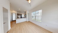 Located at 2611 E Braker Ln in Austin, TX, this well-designed single-story home offers 2 bedrooms and 2 bathrooms within a thoughtfully laid-out floor plan. The living room greets you with light wood-look flooring, large windows dressed with blinds, a ceiling fan, and a charming front entry door with a transom window that floods the space with natural light.

The kitchen is a standout, featuring gray shaker-style cabinetry, quartz countertops, a white subway tile backsplash, stainless steel appliances — including a refrigerator, range, microwave, and dishwasher — and an undermount sink set into a peninsula that opens toward the main living area.

The primary bedroom is generously sized, showcasing soaring ceilings, large windows with ample natural light, plush carpet flooring, and direct access to a private en-suite bathroom. The en-suite features a gray vanity with quartz countertop, a framed mirror, and a tub/shower combo with gray subway tile surround. A dedicated walk-in closet with built-in shelving and a hanging rod provides practical storage.

The second bedroom also offers carpet flooring and bright windows with outdoor views. The second bathroom mirrors the same refined finishes, including a matching gray vanity and light wood-look flooring. A private outdoor yard area is visible from the exterior view of the home.