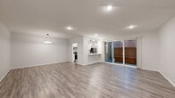 Located in the heart of West Hollywood, this well-appointed 2-bedroom, 2-bathroom single-floor residence offers a clean, contemporary aesthetic throughout. Light gray wood-look flooring extends seamlessly across all living areas, complementing a crisp white color palette and modern fixtures.

The open-concept living area is generously proportioned, anchored by a sleek circular pendant light and flowing directly into the kitchen via a breakfast bar. Sliding glass doors lead to a private patio, flooding the space with natural light. The kitchen is equipped with white shaker-style cabinetry, white quartz countertops, and a full suite of stainless steel appliances including a refrigerator, dishwasher, and range.

The spacious primary bedroom features its own dedicated closet space with built-in wire shelving systems, offering abundant organization. The second bedroom is bright and comfortable, with a large window overlooking greenery. Both bathrooms are finished in a clean, modern style with white vanities, quartz countertops, matte black hardware, framed mirrors, and glass-enclosed showers.

Four closets throughout the home provide exceptional storage. Recessed and pendant lighting is found throughout, enhancing the bright, airy ambiance of this well-designed Los Angeles residence.