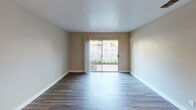 Located at 4301 Norwood Ave in Sacramento, CA, this single-floor residence offers a thoughtfully updated interior with a cohesive blend of modern finishes and functional design. The living area is bright and open, featuring durable wood-look flooring and neutral wall tones that create a welcoming atmosphere. A sliding glass door floods the space with natural light and provides direct access to a private patio overlooking a landscaped outdoor area enclosed by a white lattice fence. The entry area continues the wood-look flooring and includes a classic six-panel door with an adjacent window. The kitchen is a standout feature, showcasing white shaker-style cabinetry, a marble-look quartz countertop with a breakfast bar overhang, a mosaic tile backsplash, and a full suite of stainless steel appliances including a refrigerator, dishwasher, and gas range. The bathroom is clean and efficient, with white cabinetry, a marble-look vanity countertop, wood-look flooring, and a full tub-shower combination. A convenient in-unit washer is tucked just off the bathroom, adding everyday practicality. Throughout the unit, consistent finishes and a neutral palette provide a move-in ready environment suited for comfortable living.