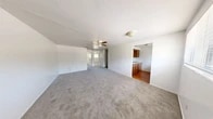 Located at 1614 SW 40th Terrace in Gainesville, FL, this single-floor unit offers a functional and straightforward layout across three bedrooms, one bathroom, and a kitchen. The open living area features neutral carpet flooring and a ceiling fan, creating a comfortable, airy atmosphere. A wide passthrough connects the living space to the kitchen, which is equipped with warm wood cabinetry, light countertops, a double-basin stainless steel sink, and hardwood-style flooring. A range is included, making the kitchen move-in ready. The generously sized primary bedroom includes a ceiling fan and a window that allows natural light and outdoor views. Each bedroom is carpeted and features its own closet with rod and shelf storage. The two additional bedrooms are similarly appointed with ceiling fans and neutral walls. The single bathroom includes a tub-shower combination, a toilet, and a wood-vanity with a sink and mirror. Throughout the unit, white walls provide a clean, neutral backdrop. Ceiling fans are present in multiple rooms, supporting air circulation. The overall layout is compact yet efficiently organized, making it a practical option for those seeking a multi-bedroom residence in Gainesville.