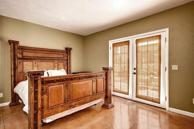 Large master bedroom with french doors to back patio. NOTE: Furniture not included. Rented unfurnished. - 2648 E Drachman St