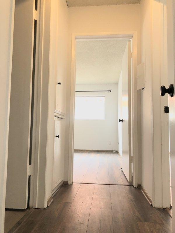 Hallway with cabinets leading to second bedroom, 14" by 10"9" - 12201 Texas Ave