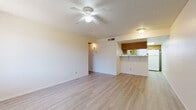 Located in Avondale, Arizona, this single-floor, 2-bedroom, 2-bathroom home offers a practical and well-organized layout. Light-toned vinyl plank flooring runs throughout the space, creating a cohesive and easy-to-maintain interior. The combined kitchen and living area anchors the home, where the kitchen features a peninsula counter with overhead cabinetry in warm wood tones, a full-size refrigerator, and a skylight that brings in natural light. The adjacent living room is bright and open, with a ceiling fan, textured ceiling, and a window that allows for ample natural light. Both bedrooms are comfortably scaled, each featuring vertical-blind-covered windows that allow light control, textured ceilings, and ceiling-mounted ventilation. The primary bedroom offers a generous footprint with ample wall space. The two bathrooms are functionally identical, each outfitted with a full tub-shower combination, a wood-cabinet vanity with a white countertop, and light flooring. A dedicated in-unit laundry area accommodates a full-size side-by-side washer and dryer with overhead shelving for storage. The overall design is clean and neutral, providing a move-in-ready environment in a convenient Avondale location.