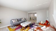 Located at 1797 Elaine Rd in Columbus, Ohio, this two-bedroom, two-bathroom home is distributed across two well-proportioned floors. The main level opens into a bright and inviting living room, where large windows usher in generous natural light, illuminating a neutral-toned space anchored by clean-lined furnishings and a boldly patterned area rug that adds a pop of color and personality. The living room flows seamlessly into a dedicated dining area, featuring light wood-tone flooring, a modern ceiling fan, and a minimalist round dining table — an ideal setting for everyday meals or casual entertaining. The kitchen is outfitted with gray shaker-style cabinetry, light stone countertops, a classic white subway tile backsplash, and a stainless steel sink, combining function with contemporary style. Upstairs, the two bedrooms offer a calm, restful retreat, each dressed in soft neutral tones with plush carpeting underfoot. The primary bedroom provides a comfortable sense of space, with natural light filtering in through a well-positioned window. Both bathrooms maintain a clean, modern aesthetic, featuring white cabinetry with matte black hardware, simple fixtures, and a crisp, minimal design. A hallway connects the upper-level rooms efficiently. Throughout, the home presents a cohesive, updated look suited for comfortable everyday living.