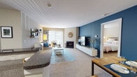 Located at Sterling Circle in Wheaton, Illinois, this single-floor residence offers a thoughtfully designed layout with a comfortable, open feel throughout. The main living area serves as the centerpiece of the home, featuring plush carpeting, a tiled wood-burning fireplace, and a bold deep-blue accent wall that anchors the space with a modern touch. A sliding glass door floods the area with natural light and provides access to an outdoor space, while a low-profile media console along the accent wall adds functional style. The open layout connects seamlessly to the dining area, creating an inviting flow ideal for everyday living and entertaining.

The galley-style kitchen is efficiently arranged, featuring warm wood cabinetry, dark granite countertops, a stone tile backsplash, and black appliances. Wood-look flooring runs underfoot, and track lighting illuminates the workspace throughout.

The bedroom offers a calm, neutral atmosphere with plush carpet, soft neutral tones, and a spacious closet with ample storage. The full bathroom includes wood-look flooring, a granite-topped vanity with rich wood cabinetry, and a full soaking tub with a shower combination, completing this well-appointed residence.