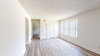 This 2-bedroom, 1-bathroom unit in Memphis, TN is thoughtfully laid out on a single floor, making efficient use of its compact footprint. The main living area features light-toned vinyl plank flooring, neutral painted walls, and a textured ceiling, creating a clean and bright atmosphere. A large window with vertical blinds allows natural light to fill the space while offering views of the surrounding greenery outdoors.

The spacious primary bedroom continues the vinyl plank flooring and includes two closets — one with louvered doors — providing ample storage. A window with vertical blinds brings in additional natural light. The second bedroom is carpeted and features a narrower horizontal window, maintaining privacy while still allowing light to enter.

The galley-style kitchen is efficiently designed with warm honey-toned wood cabinetry lining both upper and lower sections, complemented by a white countertop, a built-in sink, and appliances including a black electric range and a white refrigerator and dishwasher. Vinyl plank flooring ties the kitchen to the rest of the home.

The bathroom is clean and functional, featuring a full tub-shower combo with white tile surround, a toilet, and a wood-toned vanity. Overall, the unit offers a practical and well-maintained living environment with consistent neutral finishes throughout.