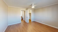 Located at 300 South St in Vernon Rockville, Connecticut, this one-bedroom, one-bathroom residence offers a thoughtfully designed single-floor layout. Warm hardwood-style flooring and crown molding carry throughout the space, lending a clean, cohesive aesthetic from room to room.

The galley-style kitchen is a standout feature, showcasing rich wood cabinetry, dark granite countertops, a stone tile backsplash, and stainless steel appliances including a range, refrigerator, microwave, and dishwasher — all set along parallel walls that maximize efficiency and storage.

The living room provides a comfortable gathering area with natural light filtering in, while the hallway connects the space with ease. The bedroom is generously sized, featuring a ceiling fan with light fixture, a wall-unit air conditioner, a large window with exterior views, and a dedicated closet with built-in storage. Crown molding continues in this room, maintaining the refined character found throughout.

The bathroom is outfitted with a full tub-and-shower combination, complete with built-in shelving for convenience. A dedicated in-unit laundry area houses a GE Profile washer and includes shelving overhead. Two closets provide ample storage. The overall ambiance is clean, neutral, and move-in ready.