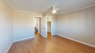 Located at 300 South St in Vernon Rockville, Connecticut, this one-bedroom, one-bathroom residence offers a thoughtfully designed single-floor layout. Warm hardwood-style flooring and crown molding carry throughout the space, lending a clean, cohesive aesthetic from room to room.

The galley-style kitchen is a standout feature, showcasing rich wood cabinetry, dark granite countertops, a stone tile backsplash, and stainless steel appliances including a range, refrigerator, microwave, and dishwasher — all set along parallel walls that maximize efficiency and storage.

The living room provides a comfortable gathering area with natural light filtering in, while the hallway connects the space with ease. The bedroom is generously sized, featuring a ceiling fan with light fixture, a wall-unit air conditioner, a large window with exterior views, and a dedicated closet with built-in storage. Crown molding continues in this room, maintaining the refined character found throughout.

The bathroom is outfitted with a full tub-and-shower combination, complete with built-in shelving for convenience. A dedicated in-unit laundry area houses a GE Profile washer and includes shelving overhead. Two closets provide ample storage. The overall ambiance is clean, neutral, and move-in ready.