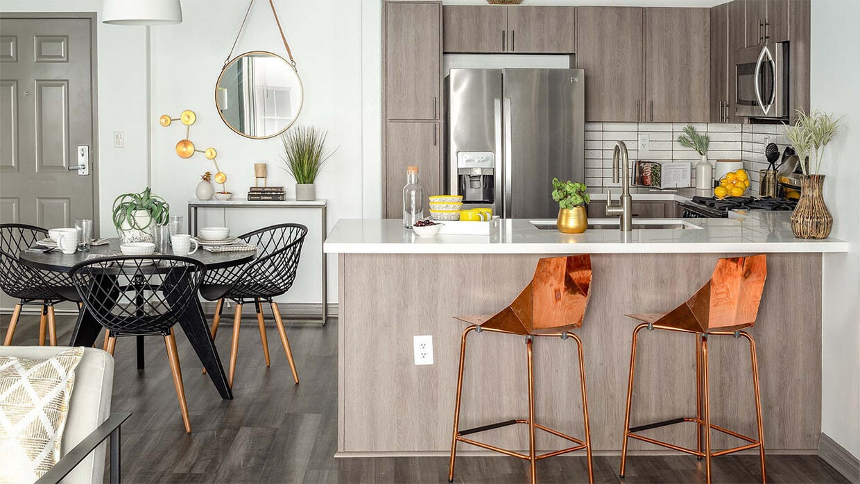 Apartment Kitchen with Stainless Steel Appliances, quartz counters and wood floors. - Shops on Pine - Bldg P