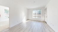 This contemporary 960 square foot apartment in Los Angeles offers a blend of style and functionality. The open-concept layout maximizes the living space, with a modern kitchen as its centerpiece. The kitchen boasts wooden cabinetry, stainless steel appliances, and a striking subway tile backsplash, creating a sleek and inviting cooking area.

The two bedrooms are generously sized, with the primary bedroom measuring 160 square feet. Both rooms feature plush carpeting and large windows that flood the spaces with natural light. The two bathrooms are elegantly designed with modern fixtures, including a bathtub in at least one, and wooden vanities that complement the overall aesthetic.

Throughout the apartment, you'll find a harmonious mix of materials, including light wood-look flooring in the main living areas and kitchen, contrasting beautifully with the carpeted bedrooms. The neutral color palette, dominated by whites and warm wood tones, creates a bright and airy atmosphere.

Storage is ample, with three closets strategically placed throughout the home. The apartment also includes a hallway, enhancing the flow between rooms. Large windows in the living areas and bedrooms not only provide natural light but also offer pleasant views of the surroundings.

This single-story apartment combines contemporary design with practical living, making it an ideal urban dwelling in the heart of Los Angeles.