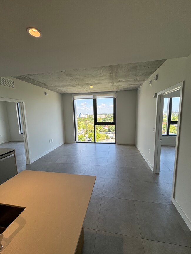 Living Room Floor to Ceiling Windows - 138 NW 31st St Apartment