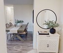 This 960 square foot apartment offers a thoughtfully designed layout with 2 bedrooms and 2 bathrooms. The open-concept living area combines the kitchen, dining room, and living room, creating a spacious and inviting atmosphere. The kitchen features white cabinetry, dark countertops, and a full suite of appliances, including a built-in microwave. A separate dining area provides a cozy spot for meals, complete with a round table and contemporary lighting.

The living room is bathed in natural light from large windows and sliding glass doors that lead to a balcony, offering city views. Comfortable seating and tasteful decor create a relaxing ambiance. The primary bedroom, measuring 190 square feet, offers ample space and includes a closet. Both bedrooms feature wooden flooring and neutral color schemes, promoting a sense of calm.

The bathrooms are well-appointed with modern fixtures, including a combination bathtub and shower in one, and a stand-alone shower in the other. Tiled flooring and ample counter space add to their functionality. Throughout the apartment, the use of light colors and wooden elements creates a bright and welcoming environment. The inclusion of a closet provides additional storage space, enhancing the overall livability of this urban dwelling.