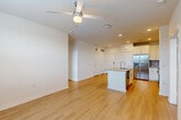Located at 10203 Karsten Blvd in Rosharon, TX, this single-story, 2-bedroom, 2-bathroom home offers a thoughtfully designed layout with modern finishes and a clean, bright aesthetic. Light hardwood flooring flows consistently throughout the entire home, complementing the crisp white walls and creating a cohesive, airy feel.

The heart of the home is a seamlessly connected open-concept kitchen, dining, and living area. The kitchen is equipped with white shaker-style cabinetry, granite countertops, stainless steel appliances including a French door refrigerator and range, and a central island with a sink — ideal for both cooking and casual dining. Recessed lighting and a ceiling fan enhance the space's functionality.

The dining area transitions naturally into the living room, where large windows invite abundant natural light and views of the surrounding neighborhood. Both bedrooms are comfortably sized, each featuring a ceiling fan, a large window with outdoor views, and hardwood flooring. The spacious primary bedroom includes access to a well-appointed en-suite bathroom featuring a granite-topped white vanity, a large mirror, and a tub. Three closets throughout the home, including walk-in options with wire shelving systems, provide generous storage. A dedicated laundry area and pantry round out the practical amenities of this efficiently designed residence.
