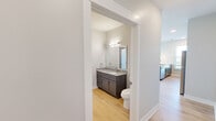Located in Indianapolis, IN, this well-designed one-bedroom, one-bathroom residence offers a thoughtful layout across its single primary floor. The open-concept kitchen and living area serves as the heart of the home, showcasing gray shaker-style cabinetry, granite countertops, a center island with a undermount sink, pendant lighting, subway tile backsplash, and a full suite of stainless steel appliances including a refrigerator, range, microwave, and dishwasher. Light hardwood-style flooring flows throughout the main living areas, complementing the clean, neutral color palette.

The bedroom is a comfortable, carpeted retreat featuring a ceiling fan, multiple windows with blinds, and direct access to the hallway. Natural light fills the room, which also offers views of the Indianapolis skyline, including Lucas Oil Stadium.

The full bathroom is well-appointed with dark-stained cabinetry, a granite vanity top, a large mirror with overhead lighting, and hardwood-style flooring. A stacked washer and dryer unit is conveniently integrated into the bathroom space. A separate water closet provides added privacy.

A connecting hallway ties all rooms together efficiently. The outdoor views of downtown Indianapolis add a distinctive urban character to this move-in ready residence.