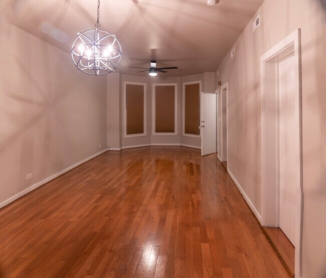 Large living and dining space, brand new lighting fixtures, light gray walls with white trim - 1537 N Talman Ave