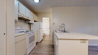 Located at 7150 Bent Tree Boulevard in Columbus, Ohio, this single-floor, one-bedroom, one-bathroom residence offers a practical and cohesive layout designed for comfortable everyday living. Wood-style plank flooring runs consistently throughout the unit, providing a clean and modern aesthetic in every room.

The galley-style kitchen is efficiently arranged, featuring white cabinetry, a built-in microwave, an electric range, a full-size refrigerator, and a double-basin sink with a pull-down faucet — all set against light countertops that maximize the sense of brightness. The kitchen flows conveniently toward the living area, which benefits from natural light through a window fitted with vertical blinds.

The bedroom is a well-sized retreat with its own window, textured ceiling, and wood-style flooring, offering a quiet and comfortable space. A dedicated walk-in closet adjoins the bedroom, equipped with wire shelving racks that provide ample storage.

The full bathroom includes a single-sink vanity with under-cabinet storage, a toilet, and a full-size soaking tub with shower combination, all finished in a clean, neutral palette. Additional features include a wall-mounted HVAC unit and ample outlet placement throughout. The unit presents a straightforward, move-in-ready layout suited for efficient single-occupant living.