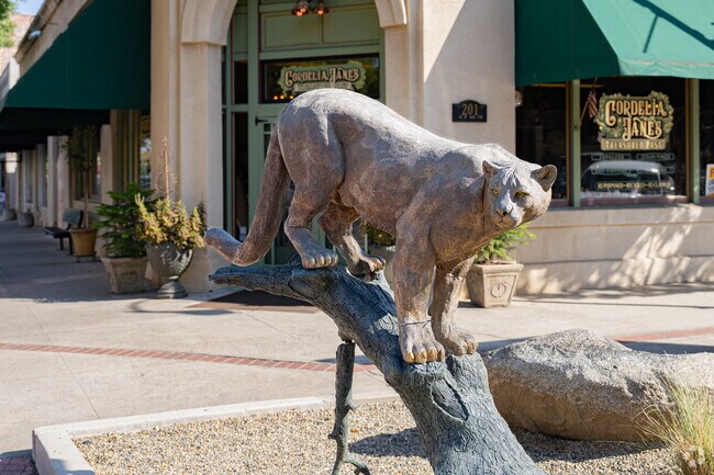 A large cat bronze statue stays alert on this corner of downtown Exeter.