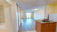 Located at Kipps Lane in London, Ontario, this 1-bedroom, 1-bathroom unit offers a practical and comfortable layout across a single floor. The combined kitchen and living area forms the heart of the unit, where light wood-style flooring flows throughout and warm neutral tones create a clean, inviting atmosphere. The kitchen is well-appointed with warm wood cabinetry, granite-style countertops, a tile backsplash, and white appliances including a stove and refrigerator. A peninsula with a stainless steel sink bridges the kitchen to the living area, offering a natural divide while maintaining an open feel. The living room is generously proportioned, featuring a sliding glass door that opens onto a private balcony with scenic views of surrounding greenery. The bedroom is a comfortable size, fitted with light wood flooring, a large window that brings in natural light and outdoor views, and a full-width sliding door closet for ample storage. The bathroom includes a full-sized soaking tub with an overhead shower, framed by clean, large-format tile surround in neutral tones. Textured ceilings and consistent light-toned walls throughout contribute to a bright, cohesive aesthetic across the entire unit.