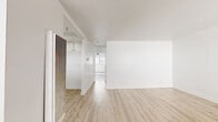 Located at 13628 Kornblum Ave in Hawthorne, California, this single-story, one-bedroom, one-bathroom unit offers a clean, modern aesthetic defined by a consistent light wood-tone flooring that runs throughout every room, creating a cohesive and airy atmosphere.

The combined living room and kitchen area forms the heart of the unit. The living space is open and well-proportioned, featuring crisp white walls, a ceiling fan with integrated lighting, and a large window fitted with vertical blinds that allows ample natural light to filter in. A front entry door with a sidelight adds to the brightness of the space.

The kitchen is efficiently laid out in a U-shaped configuration, featuring white cabinetry with ample upper and lower storage, white countertops, a gas range, a sink, and a dishwasher. An overhead light fixture keeps the workspace well-illuminated.

The spacious primary bedroom continues the light, neutral palette with white walls, a window with vertical blinds for natural light, and a ceiling fan. It is complemented by a dedicated walk-in closet with built-in hanging rods and shelving.

The bathroom is clean and functional, offering a full-size soaking tub with shower, a toilet, and a vanity with under-sink storage, all finished in white.