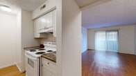 Located at 837 SW Tyler St in Topeka, Kansas, this single-floor, 2-bedroom, 1-bathroom unit offers a practical and comfortable layout. Warm hardwood flooring runs throughout, complementing the neutral white walls and textured ceilings found across the living spaces.

The galley-style kitchen is efficiently designed with white cabinetry, dark laminate countertops, a double-basin sink, and white appliances including an electric range and refrigerator. It opens toward the living room, which is bright and open, featuring a large sliding glass door dressed with vertical blinds that allows natural light to fill the space.

Both bedrooms are well-proportioned, with the primary bedroom offering a generous footprint. Each room features hardwood floors, large windows that bring in natural light and exterior views, and access to the hallway connecting the unit's spaces. Four closets are distributed throughout, providing ample storage.

The bathroom is clean and functional, featuring a full-size soaking tub with an overhead shower and built-in shelving. A dedicated utility room and a connecting hallway round out the floor plan, which is compact yet thoughtfully organized. Overall, the unit presents a bright, straightforward living environment well-suited for everyday comfort.