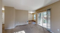 Located at 1012 Hidden Creek Dr NE in Keizer, Oregon, this single-floor, 2-bedroom, 2-bathroom home offers a practical and comfortable layout. The living room is finished with plush carpet and neutral warm-toned walls, and features a sliding glass door that fills the space with natural light and provides direct access to the outdoors, where mature trees are visible beyond the patio.

The galley-style kitchen is efficiently designed with white cabinetry, light laminate countertops, and wood-look flooring. It includes a full suite of white appliances — refrigerator, electric range, dishwasher — with ample upper and lower cabinet storage. The kitchen connects to a dedicated dining area that benefits from a window overlooking the greenery outside.

Both bedrooms are carpeted and finished with the same warm neutral palette found throughout the home. The primary bedroom offers a generous footprint with access to a closet, while the second bedroom is well-proportioned and similarly comfortable. Each bedroom connects to the hallways with dedicated closet spaces.

The two bathrooms are clean and functional, featuring wood-look flooring, a vanity with mirror, and a tub-shower combination. Two hallways connect the main living areas to the private sleeping quarters, giving the layout a clear and logical flow throughout.