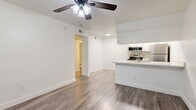 Located at 950 E Southern Ave in Mesa, AZ, this efficiently designed one-bedroom, two-bathroom unit offers a thoughtful single-floor layout that maximizes every square foot. The open-concept living and kitchen area serves as the heart of the home, featuring durable wood-look flooring, bright white walls, and a ceiling fan with integrated lighting. A large window allows natural light to fill the living space, offering a view of lush greenery outside.

The kitchen is well-appointed with crisp white shaker cabinetry, light quartz countertops, a subway tile backsplash, and a full suite of stainless steel appliances including a refrigerator, electric range, over-the-range microwave, and dishwasher. A peninsula with an undermount sink adds additional prep space and separates the kitchen from the living area.

The bedroom is carpeted for comfort and includes a window with views of surrounding greenery, offering a quiet and private retreat. A dedicated closet and hallway provide practical storage solutions.

Both bathrooms are finished with modern touches, including one featuring a tub/shower combination adorned with large-format marble-look tile, wood-look flooring, and clean white fixtures. The overall aesthetic throughout is clean, bright, and move-in ready.