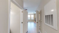 Located at 823 S Church St in Greenville, SC, this efficiently designed single-floor unit offers a smart, functional layout that maximizes every square foot. The open living area features light-toned hardwood-style flooring, neutral beige walls, and dual ceiling fans that enhance airflow and comfort. Large windows flood the space with natural light and provide views of the surrounding Greenville cityscape, creating a bright and airy atmosphere throughout.

The kitchen is a standout feature, outfitted with sleek dark espresso cabinetry, granite-style countertops, a stainless steel undermount sink, and a full suite of stainless steel appliances including a range, microwave, and dishwasher. The cabinetry extends to the upper walls, offering generous storage for a compact space.

The full bathroom continues the cohesive design aesthetic with dark wood-toned vanity cabinetry, a granite-top single-sink vanity, a large framed mirror, tile flooring, and a full tub-shower combination. A dedicated closet and in-unit laundry area add practical convenience. The unit's crisp white trim, clean lines, and consistent finishes throughout deliver a polished, move-in-ready living environment in the heart of Greenville.
